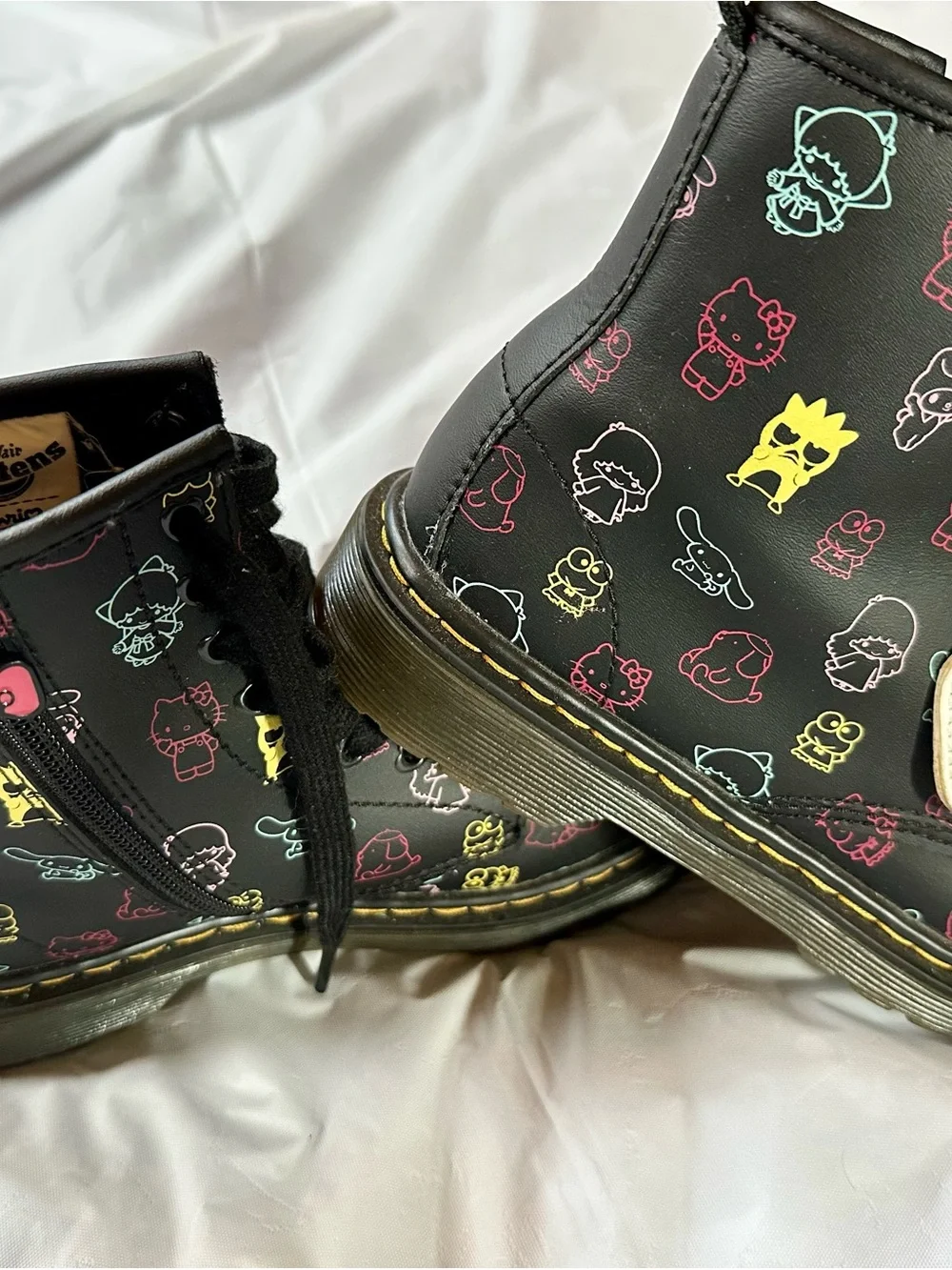 Dr. Martens Kids Black Boots with Multicolor Sanrio Print and Pink Bow Charm